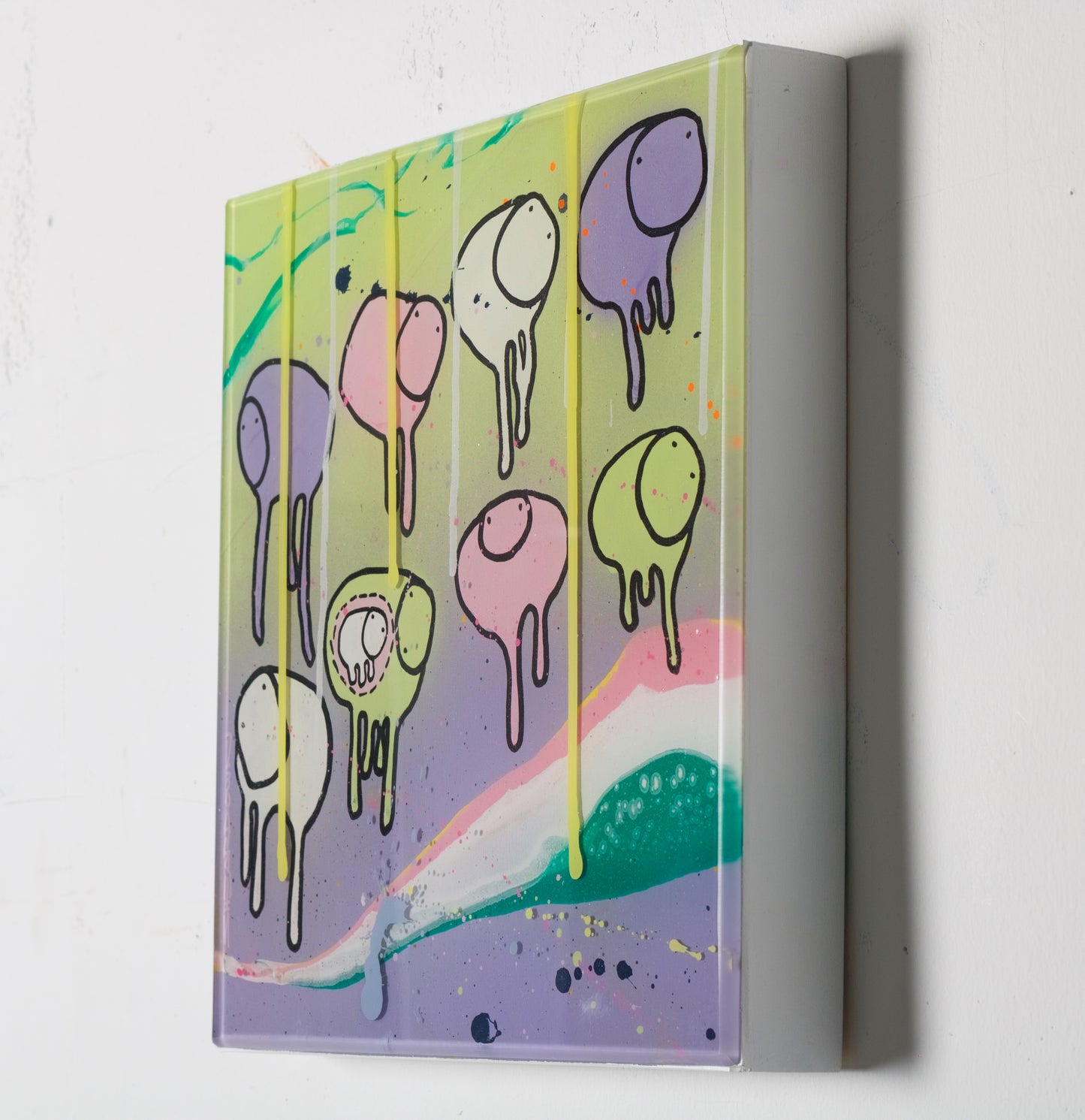 Side view of painting RAINING COWS 'Loose Ends' by Toronto artist Morgan Sheardown hanging on a white wall, showing colorful purple, pink, and green swirls, dripping green paint, and cows.