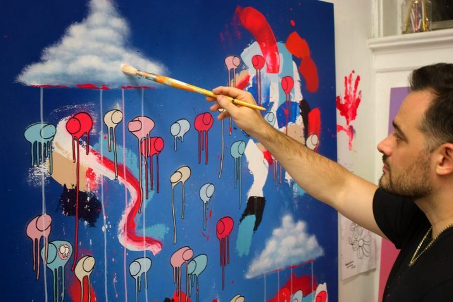 Close-up of Morgan Sheardown painting clouds on RAINING COWS — Magenta's Stream, mixed media and resin on wooden panel.