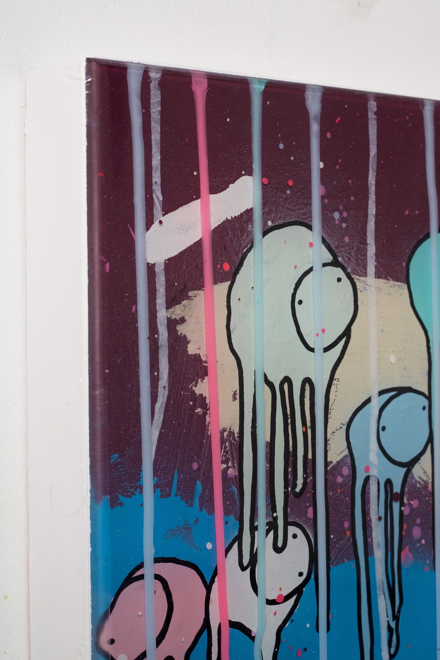 Abstract art piece with colorful drips on a white background