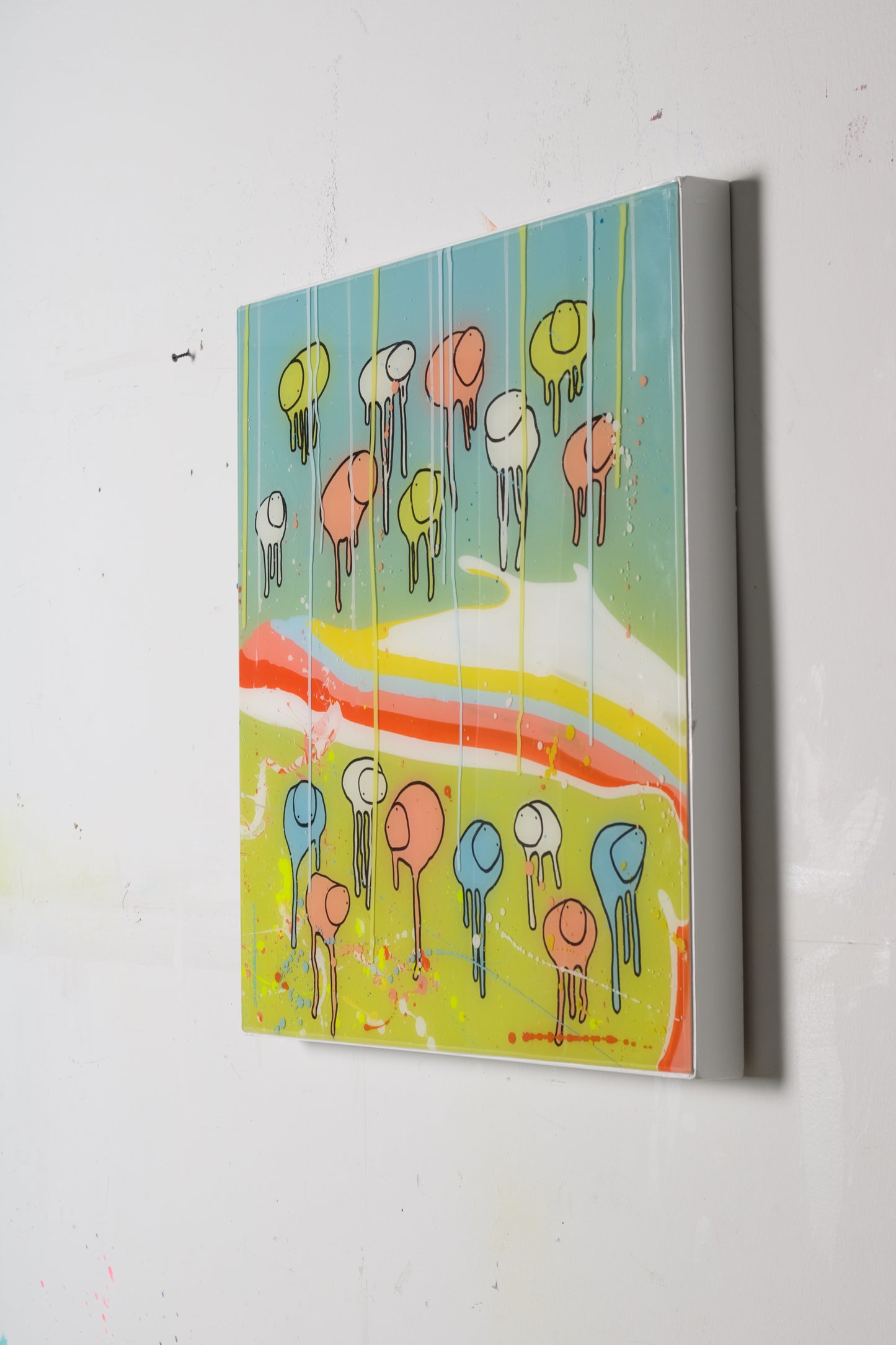 A colorful artwork featuring an abstract representation of cows with human-like faces on a blue and greeen background with splashes of yellow, orange, and other colors.