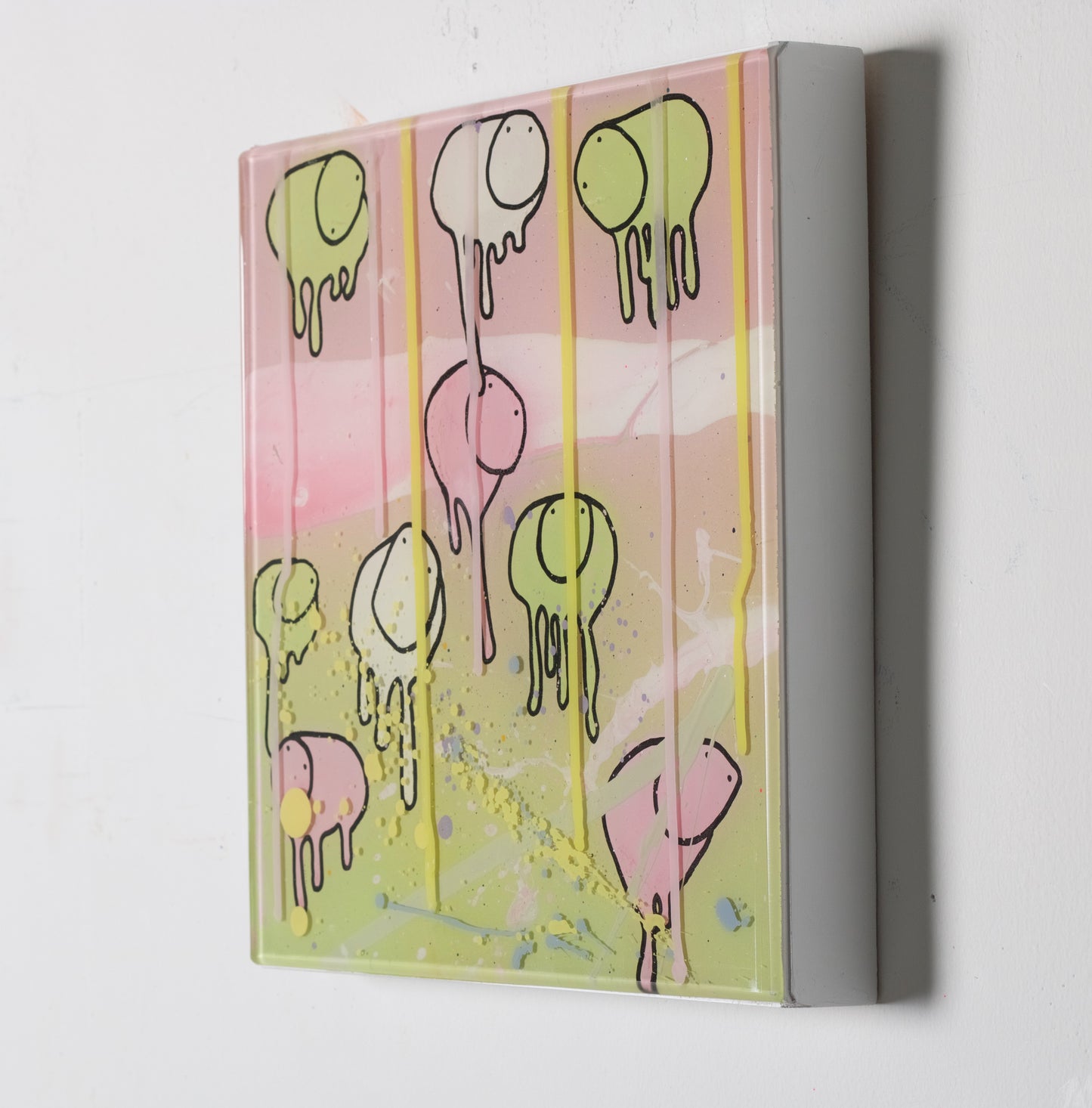 Side view of painting RAINING COWS 'Loose Ends' by Toronto artist Morgan Sheardown hanging on a white wall, showing colorful pink, and green swirls, dripping yellowpaint, and cows.