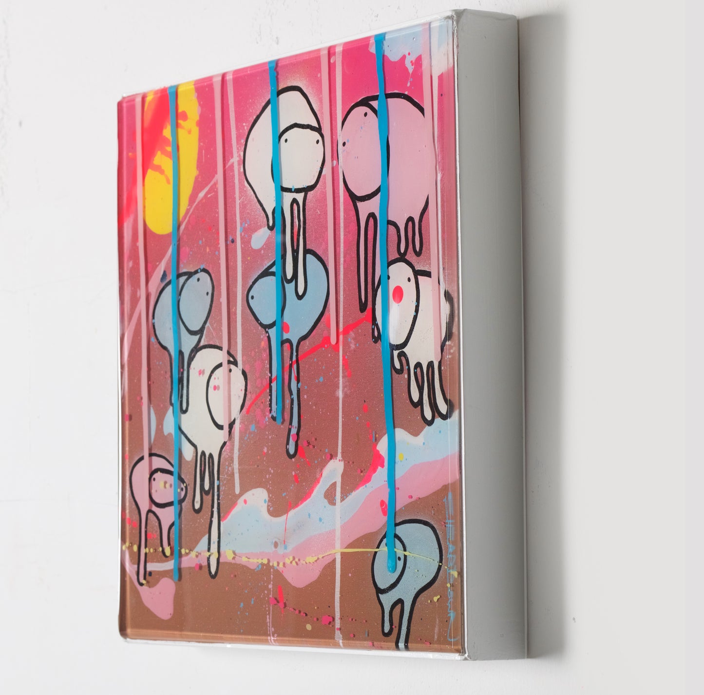 Side view of painting RAINING COWS 'Loose Ends' by Toronto artist Morgan Sheardown hanging on a white wall, showing colorful brown, pink, and white swirls,  yellow sun, and cows.