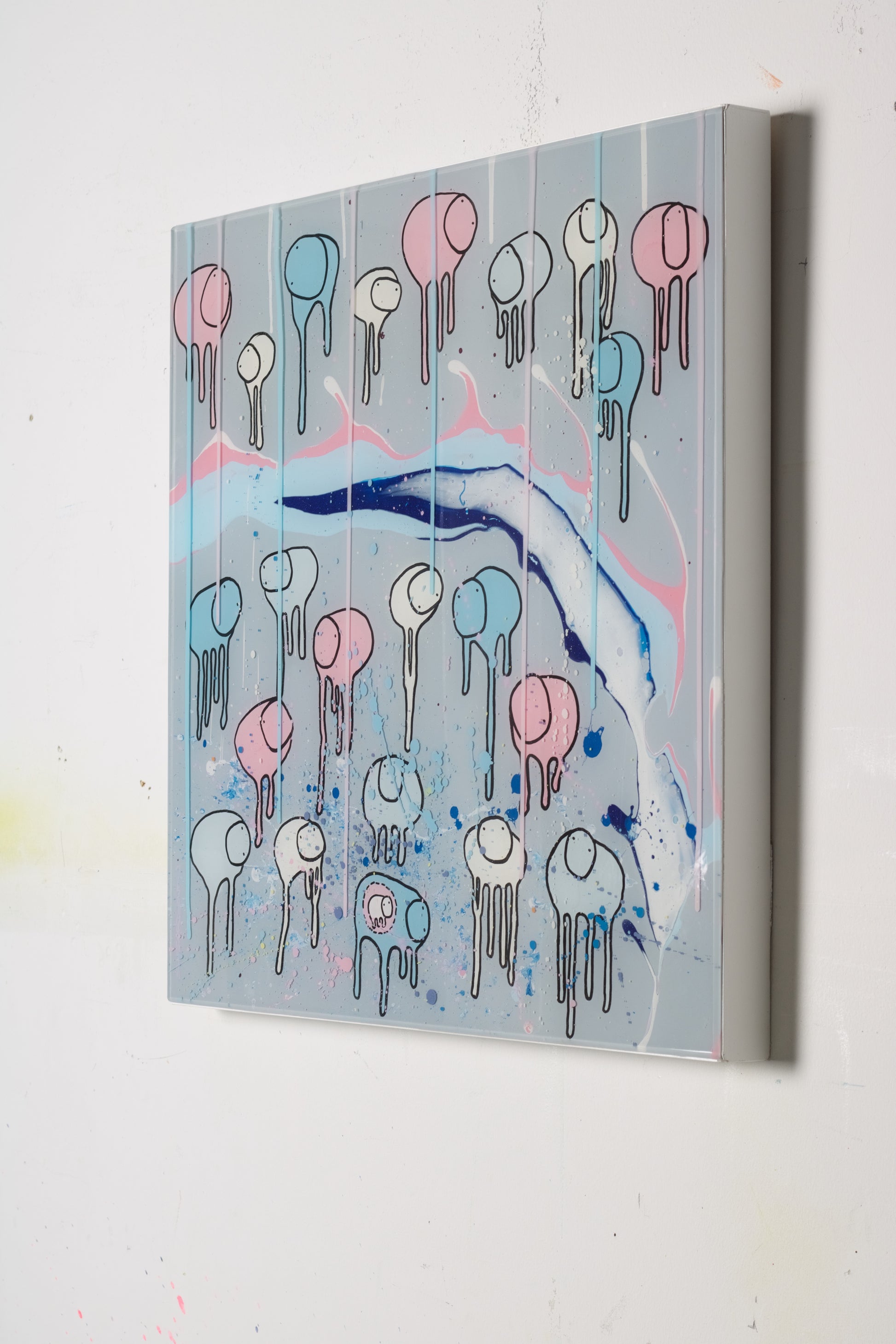 A colorful artwork featuring a herd of stylized cows with abstract and surfer-inspired designs, set against a multi-layered painted resin background with blue and pink splashes.